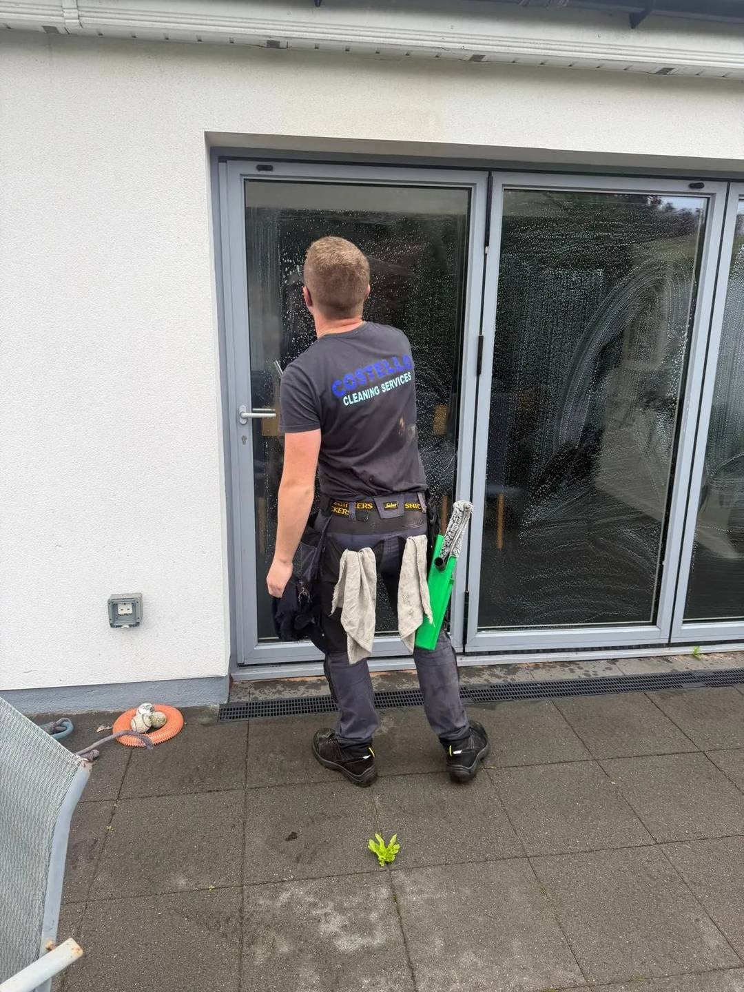 Adam Costello at work, Costello Cleaning Services logo on his shirt